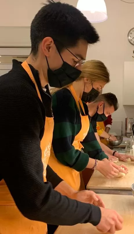students cook dishes in a professional cooking class at bologna cucina cultura italiana